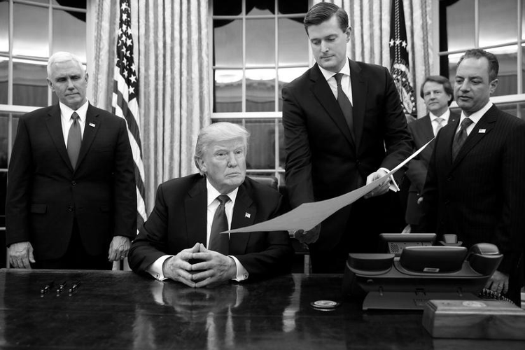 President Donald Trump prepares to sign confirmation of James Mattis as United States Secretary of Defense, 20 January 2017, in the Oval Office of the White House, in Washington, D.C.  Present for Mr. Trump's first presidential signing are (L-R) Vice-President Mike Pence, Staff Secretary Rob Porter, White House Counsel Don McGahn, and Chief of Staff Reince Priebus.  (Photo by Jonathan Ernst/Reuters)